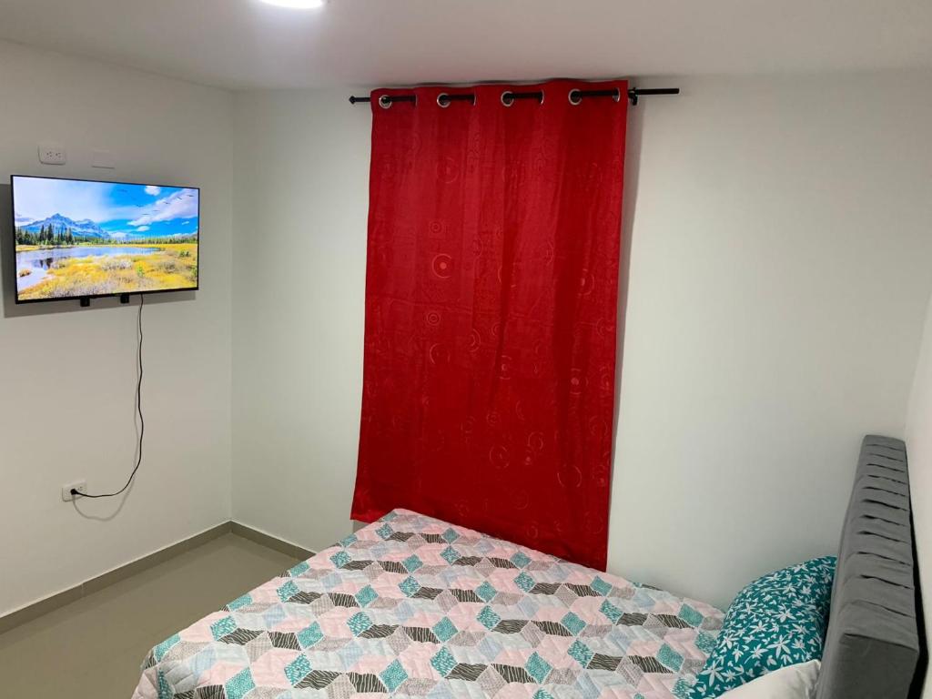 a bedroom with a red curtain and a bed at APARTAMENTO EN VALLEDUPAR in Valledupar