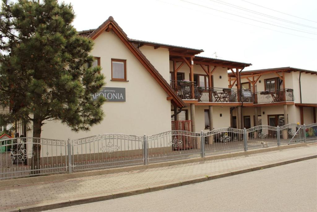 a building with a fence in front of it at Apolonia in Dziwnów