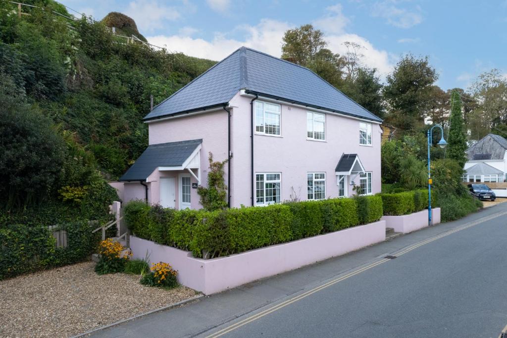 a white house on the side of a street at Ruby Cottage - Beachside Cottage with Views in Saundersfoot