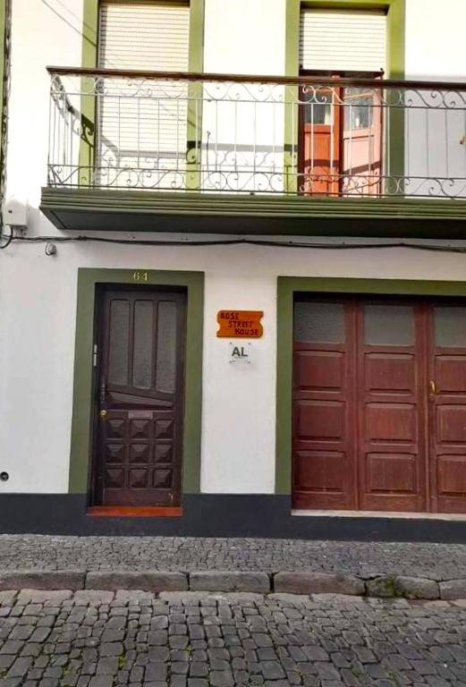 two doors on the side of a building at Rose Street House in Angra do Heroísmo
