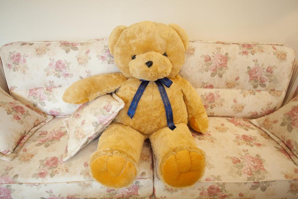 a brown teddy bear sitting on a couch at Blue Cotton Candy B&amp;B in Taitung City