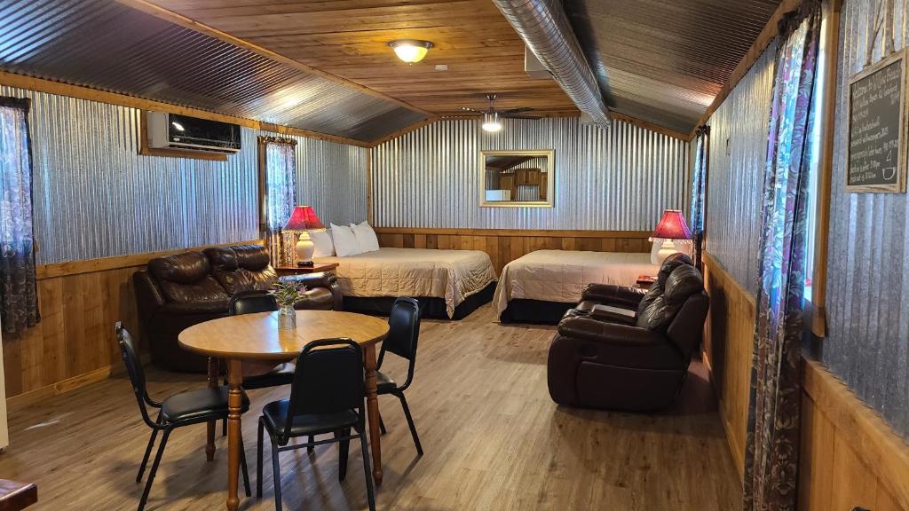 a hotel room with a bed and a table and chairs at Willow Beach RV Park & Marina in Graford