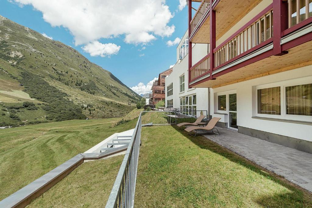 a house with two benches on the side of it at Apartment in Obergurgl with shared fitness in Obergurgl