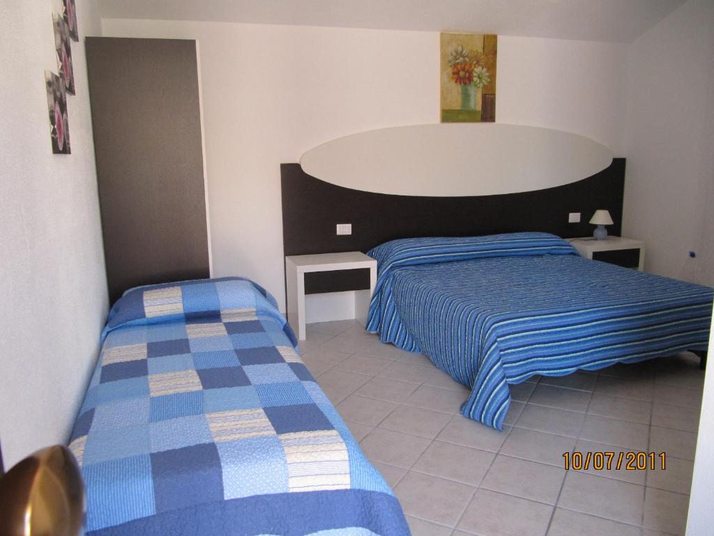 Posteľ alebo postele v izbe v ubytovaní Residence Olbia