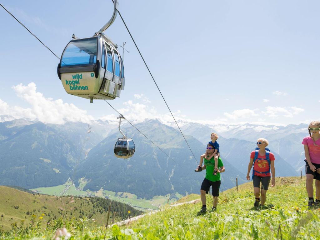 a group of people on a mountain with a cable car at Apartment in Bramberg am Wildkogel with balcony in Bramberg am Wildkogel