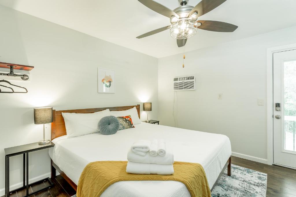 a bedroom with a white bed and a ceiling fan at 14 The Nelson Room - A PMI Scenic City Vacation Rental in Chattanooga