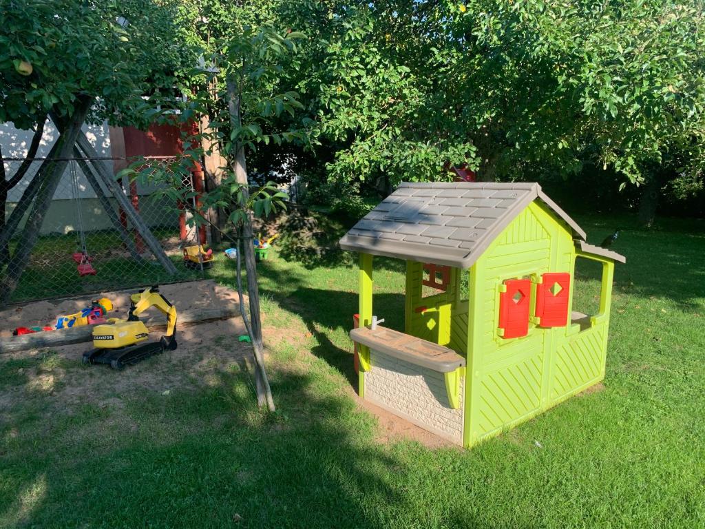 a small green play house in the grass at Ferienhof Klein in Gunzenhausen