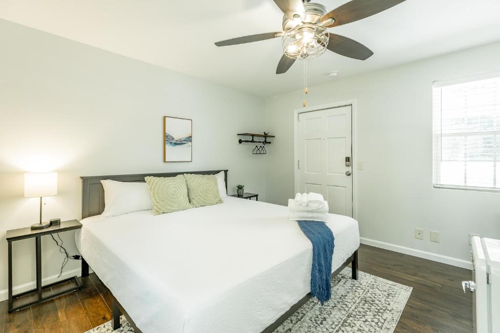 a bedroom with a white bed and a ceiling fan at 13 The Eero Room - A PMI Scenic City Vacation Rental in Chattanooga