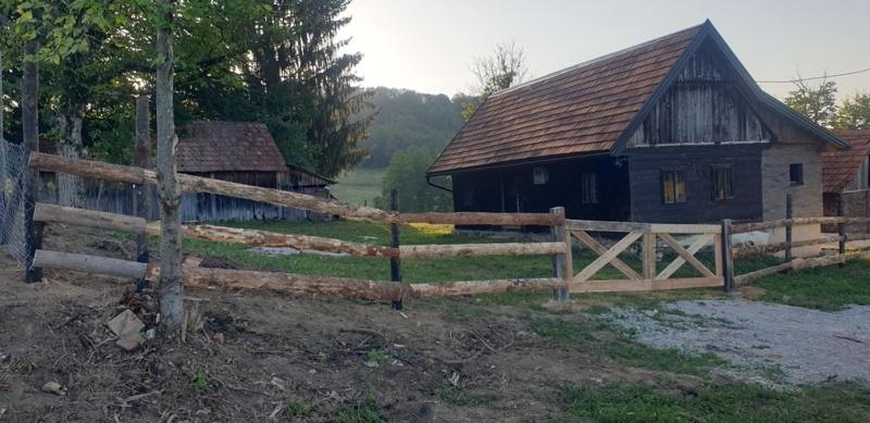 a wooden fence in front of a barn at Oaza Mister D 