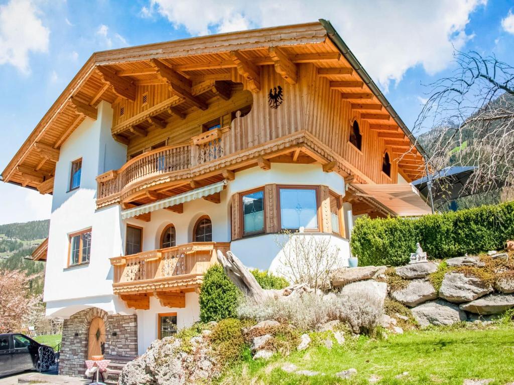 a house in the mountains with a wooden roof at Apartment with panoramic view in Ramsau