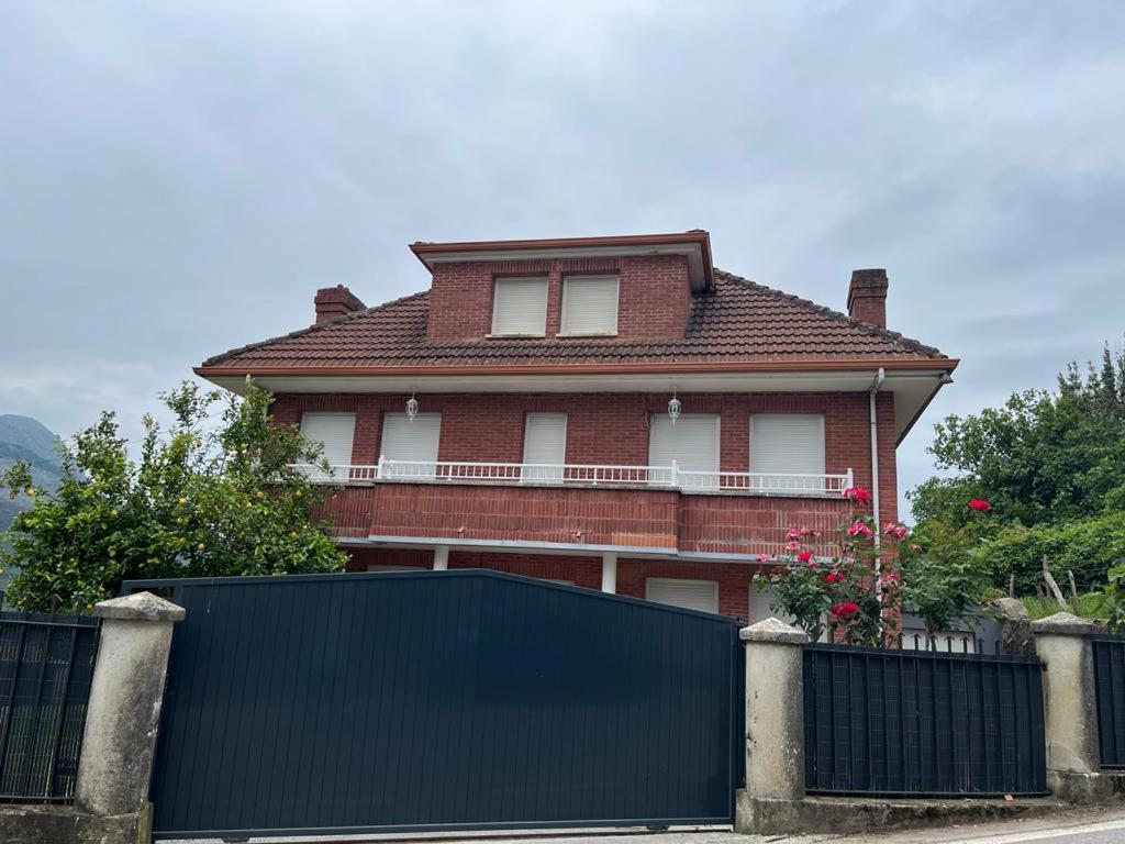 a house with a black fence in front of it at CASAMENTERA in Mentera-Barruelo