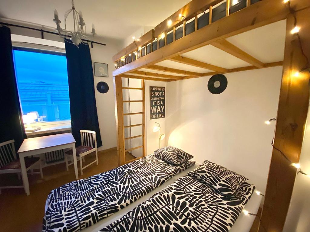 a bedroom with two beds and a bunk bed at Cozy nest in the heart of Helsinki in Helsinki