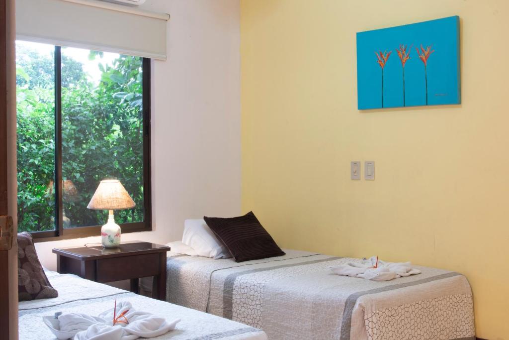 Postel nebo postele na pokoji v ubytování Apartments-Villas Playa Potrero 1