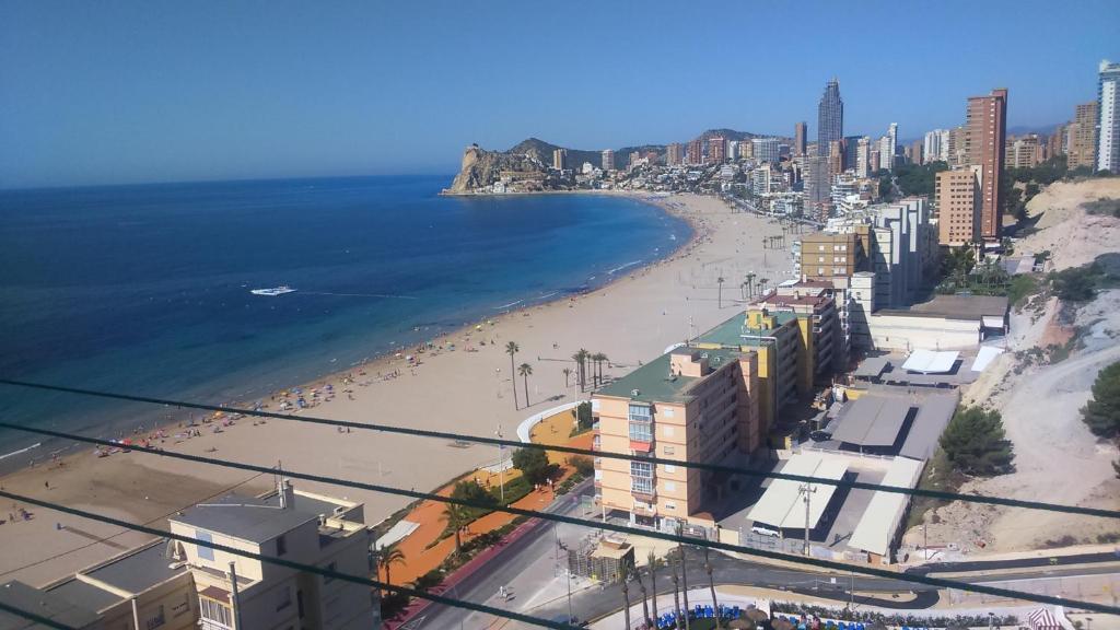 a view of a beach with buildings and the ocean at Pintor Sorolla in Benidorm