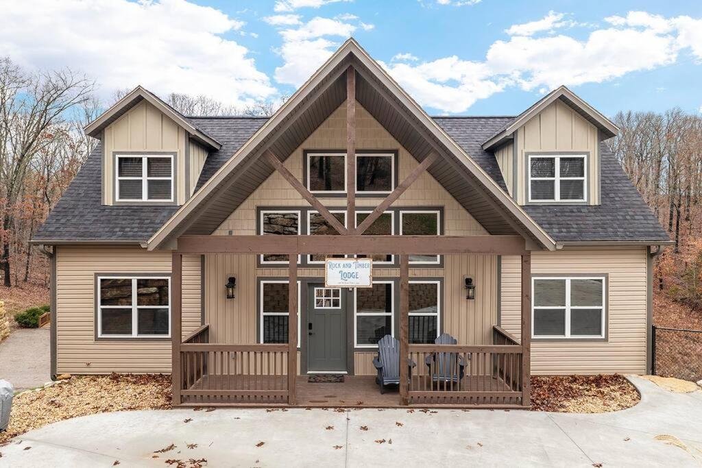 a house with a front porch and a house at Rock and Timber Lodge in Branson