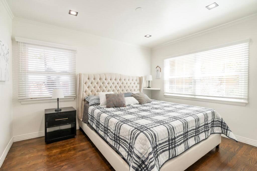 1 dormitorio blanco con 1 cama y 2 ventanas en Perfect Suite near Universal Studios, en Los Ángeles