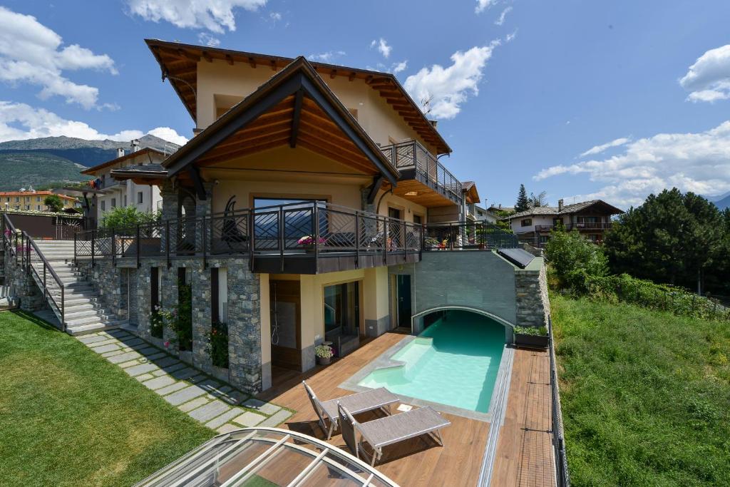 a villa with a swimming pool and a house at Casa Sogno in Aosta