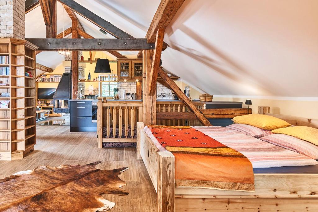 a bedroom with a large bed and a kitchen at Appartement Alpine Affair in Bad Feilnbach