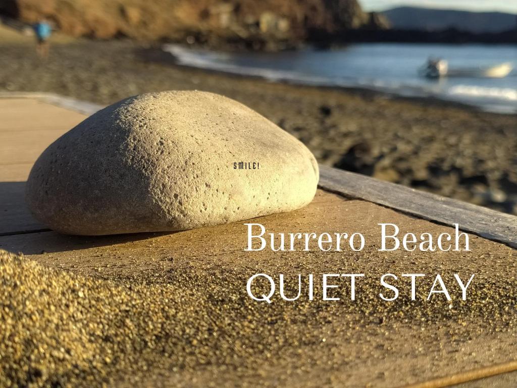 a rock sitting on top of a beach at Quiet Beach Gran Canaria in Playa del Burrero