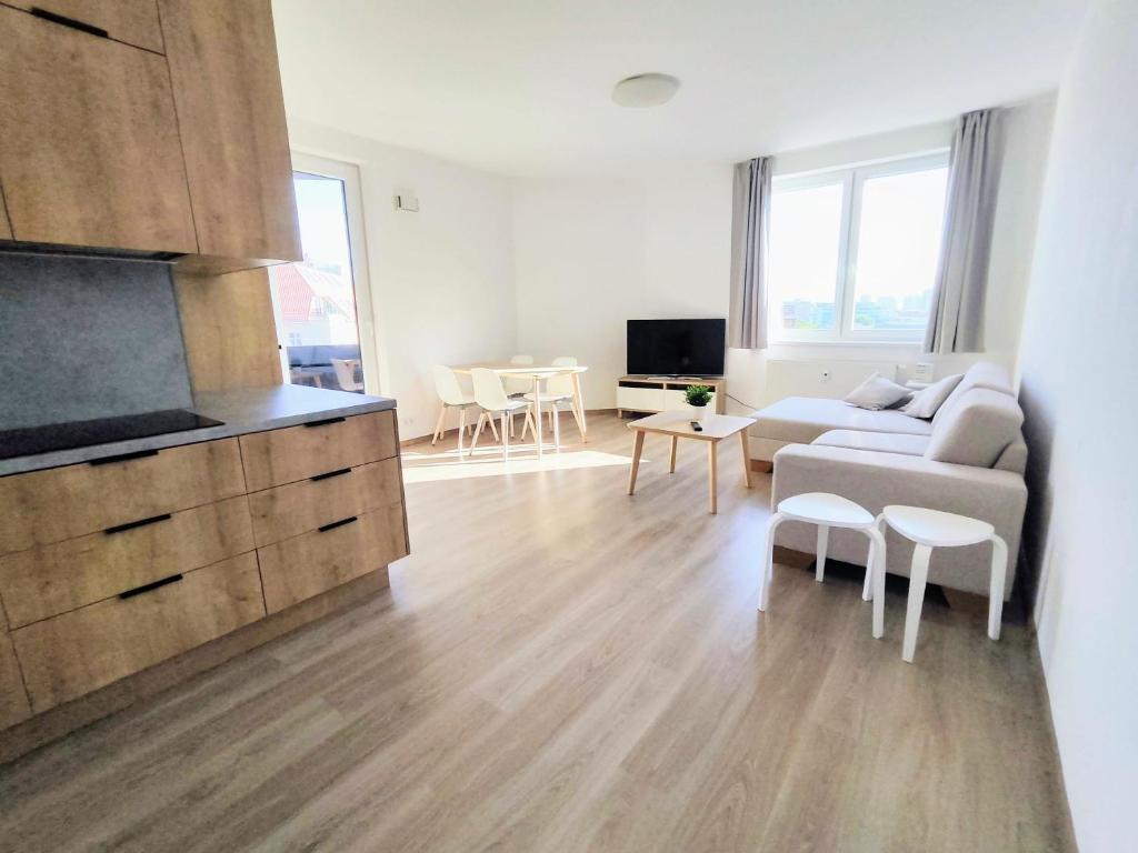 a living room with a couch and a table at Quietly oriented apartment with free parking and balcony in Bratislava