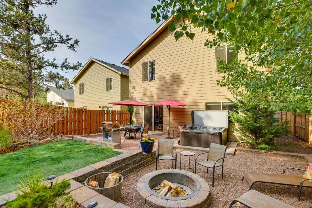 a backyard with a fire pit and a house at Bend Getaway with Private Hot Tub, Patio and Grill! in Bend