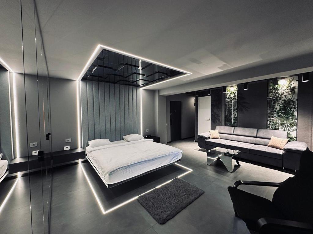 sypialnia z dużym łóżkiem i kanapą w obiekcie The HATZ w Bukareszcie