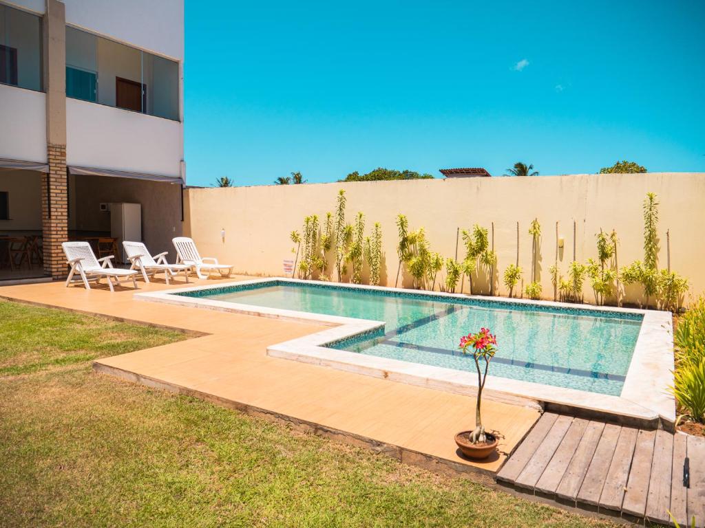 a swimming pool in the backyard of a house at Pousada Reobote in São Miguel do Gostoso