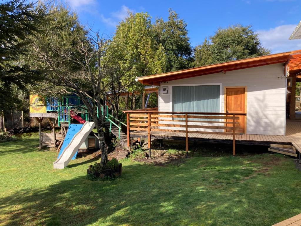 a house with a playground and a slide at El Viloche - Tiny House in Puerto Montt