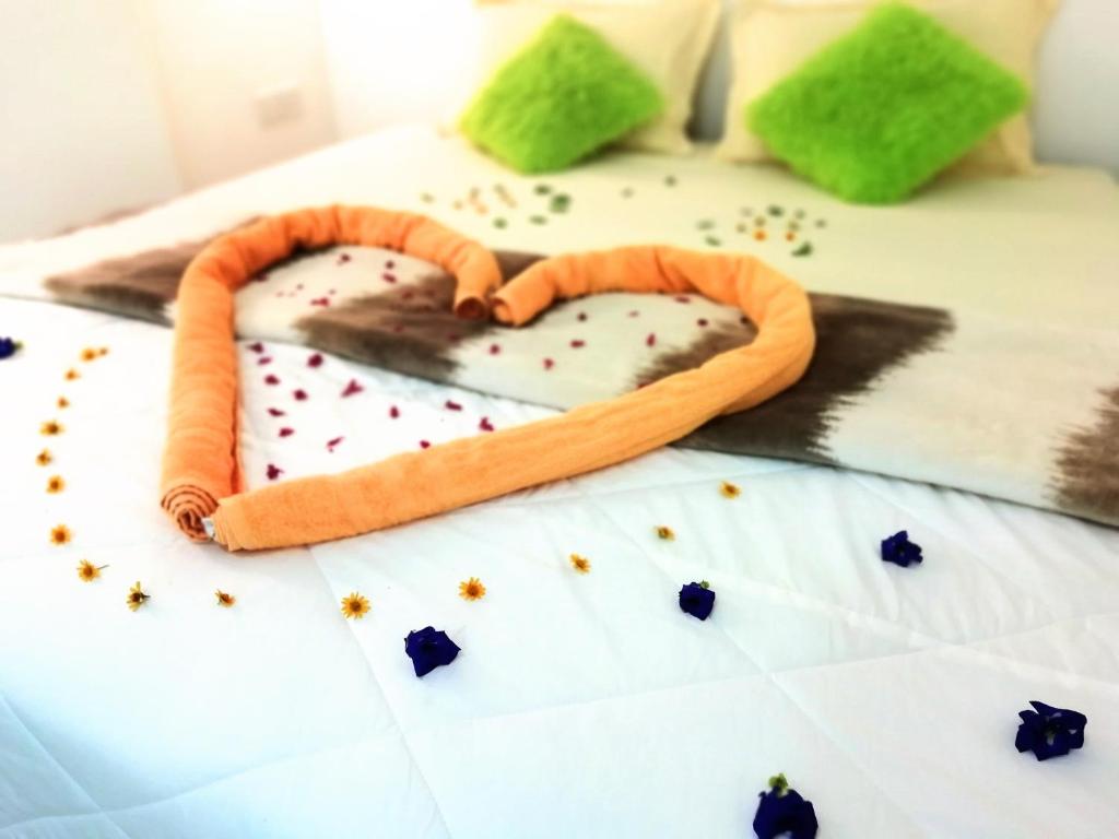 a bed with a heart made out of confetti at Ella C&D Paradise in Ella