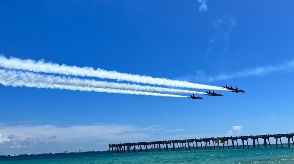 two planes are flying over a pier with smoke trails at Holiday Inn Express & Suites Gulf Breeze - Pensacola Area by IHG in Gulf Breeze