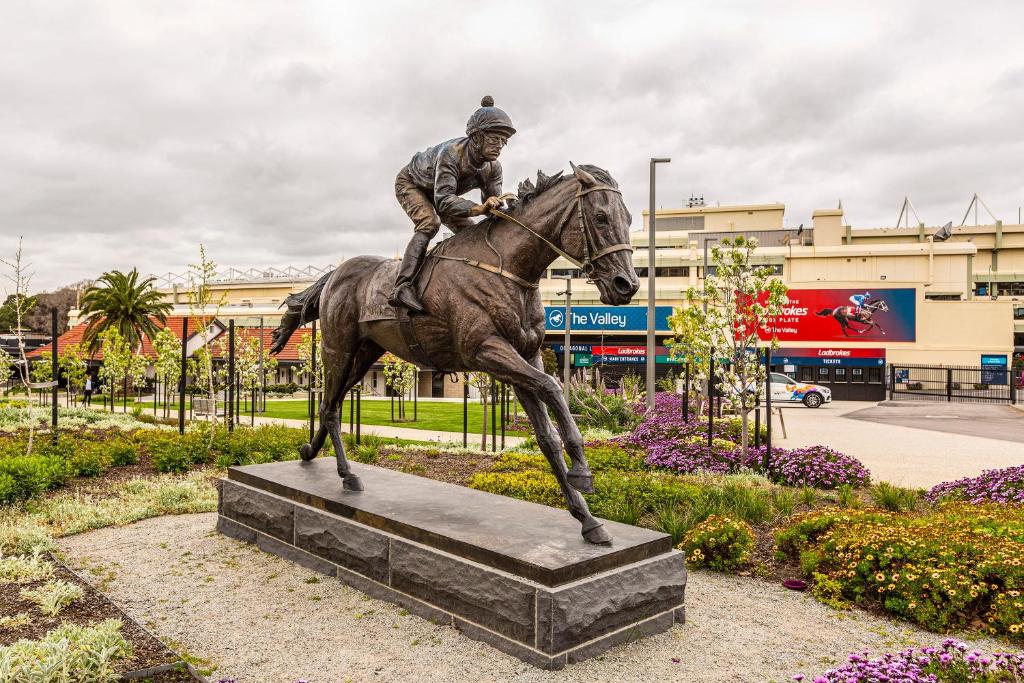 a statue of a man riding a horse at Moonee Valley Park with parking in Melbourne