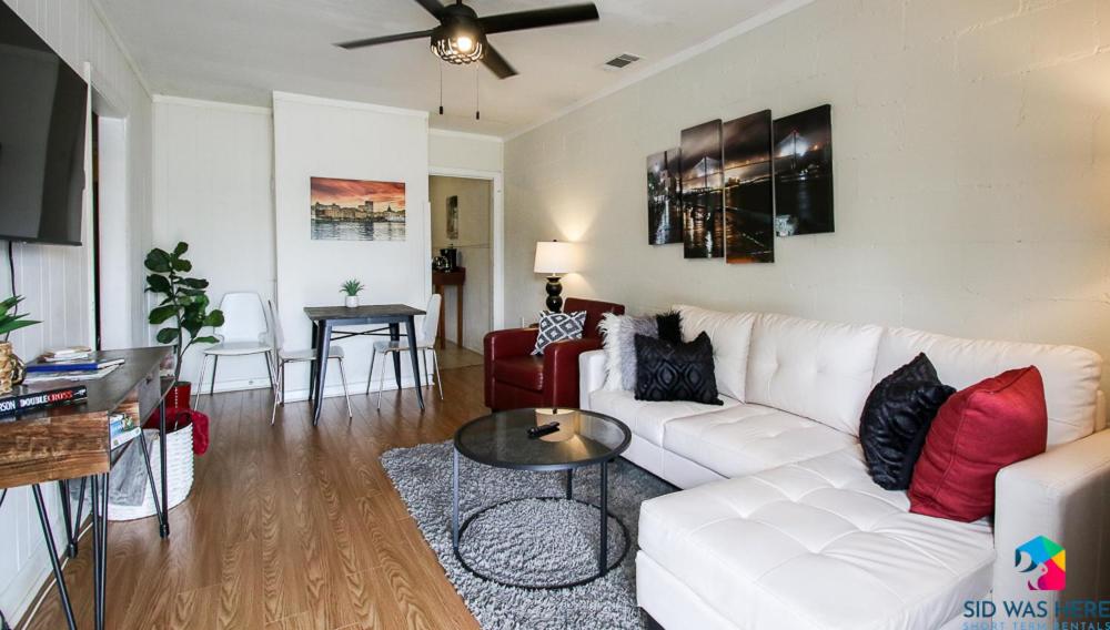 a living room with a white couch and a table at Affordable, Walkable Near Forsyth Park Free Parking in Savannah