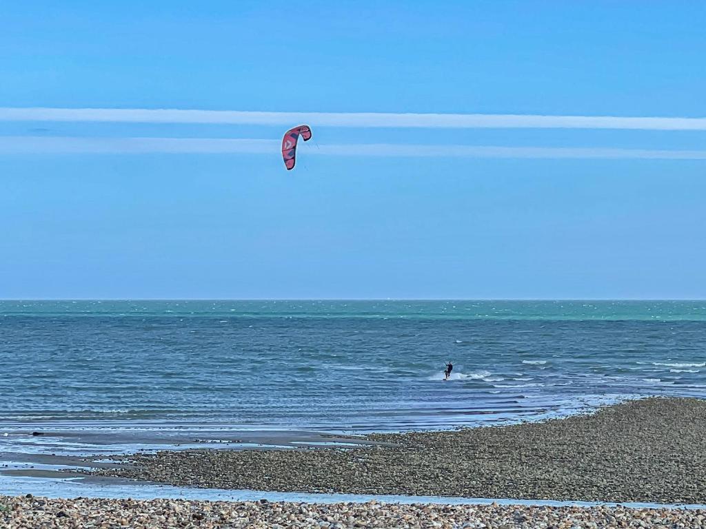 a person in the ocean flying a kite at The Old Printworks in Littlehampton