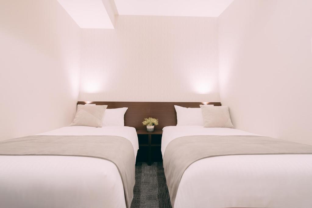Postel nebo postele na pokoji v ubytování R Hotel Honmachi