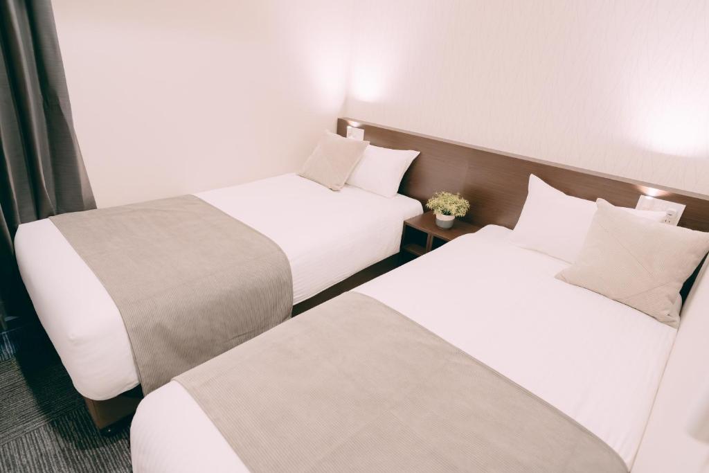 Postel nebo postele na pokoji v ubytování R Hotel Honmachi