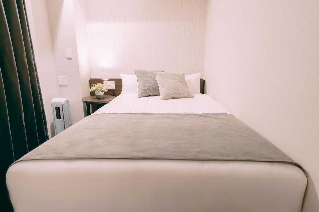 Postel nebo postele na pokoji v ubytování R Hotel Honmachi