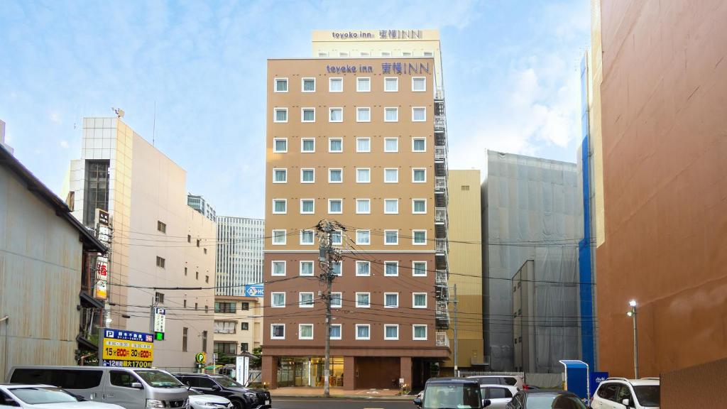 a tall building in the middle of a city at Toyoko Inn Nagoya-eki Sakuradori-guchi Shinkan in Nagoya