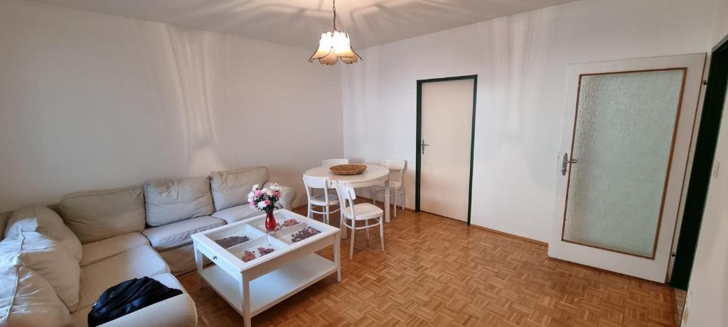 a living room with a couch and a table at Apartment in Fischamend 2 Bedroom (3 Beds) 