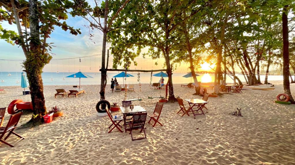 a group of tables and chairs on a beach at Vung Bau Resort in Phú Quốc
