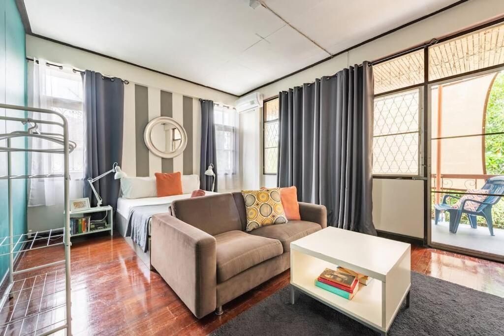 a bedroom with a bed and a couch and a chair at Bang Chak Homestay in Amphoe Phra Khanong