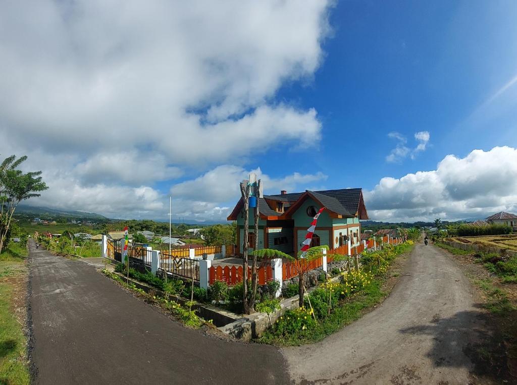 a house on the side of a dirt road at Kopa HillTop - Family Guest Home in Ruteng