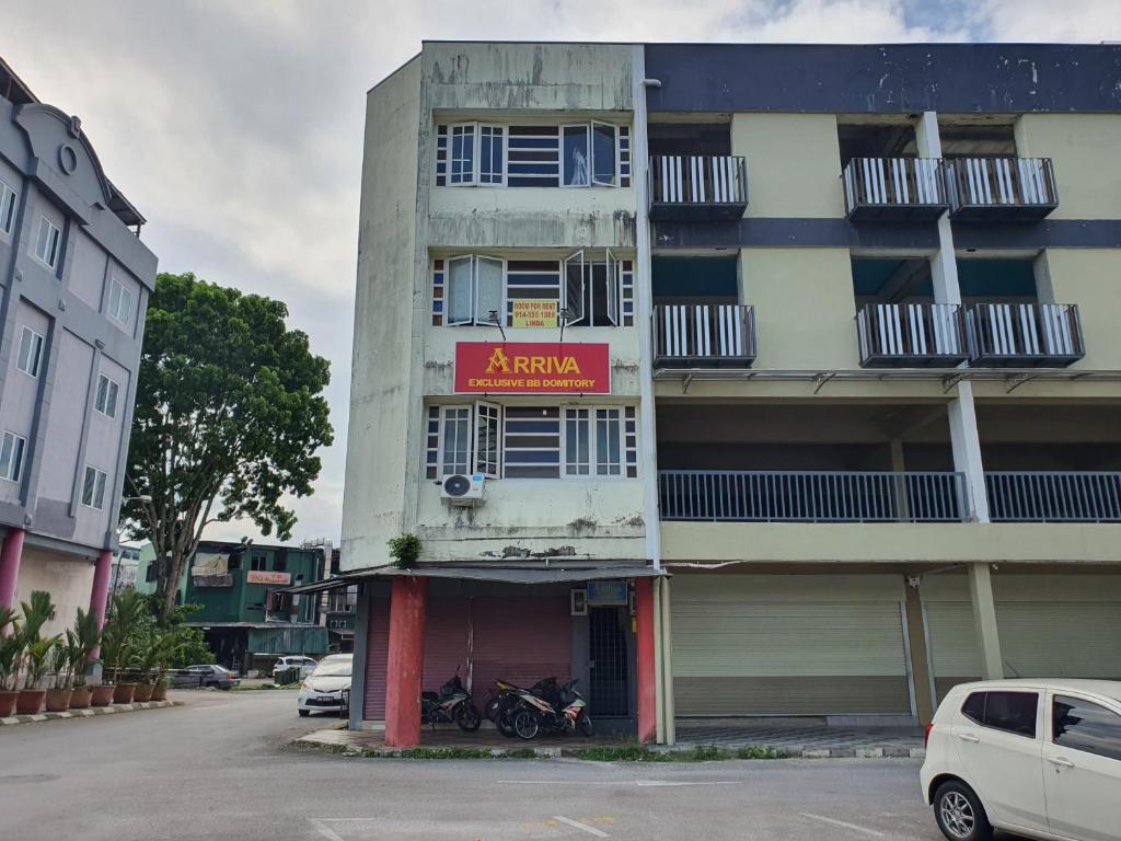 a building with a sign on the side of it at SPOT ON 90856 Arriva Travellers in Kuching