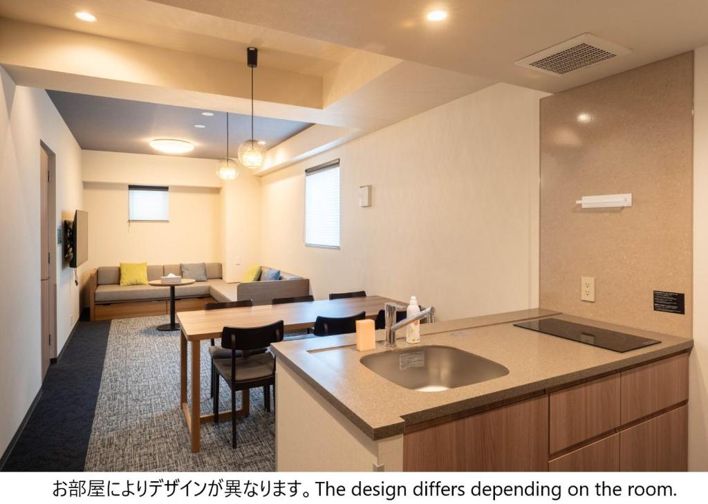 a kitchen with a sink and a living room at stayme THE HOTEL Ueno in Tokyo