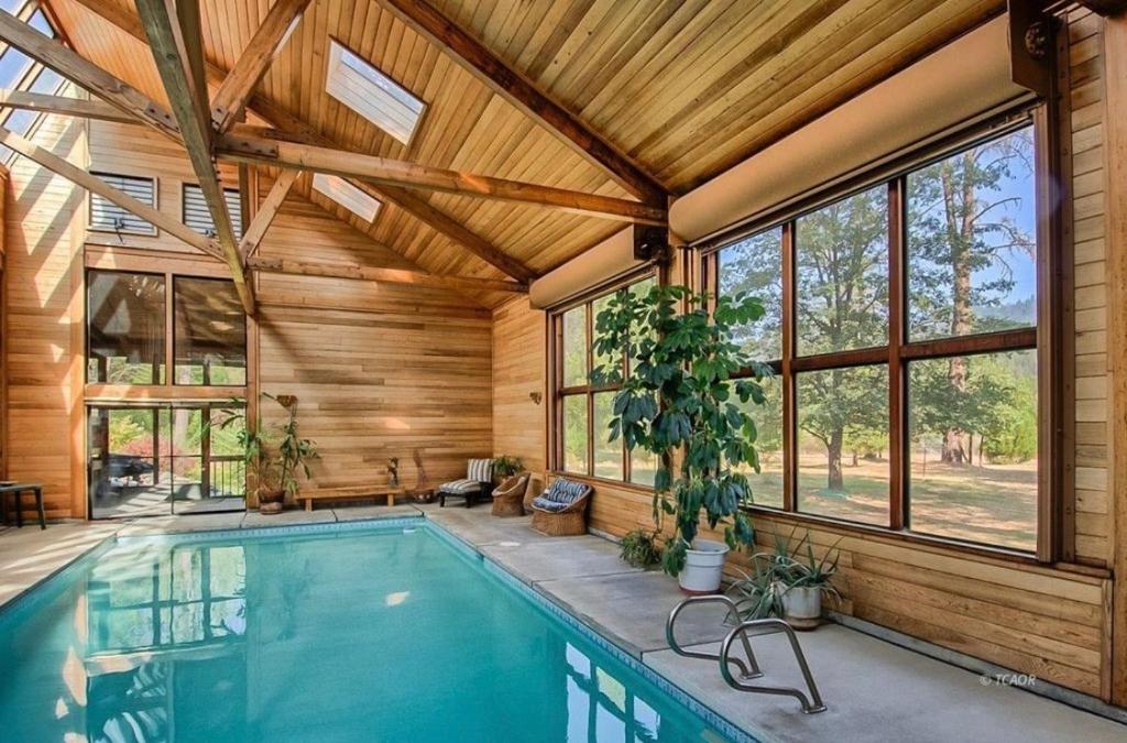 an indoor pool in a house with a wooden ceiling at River Retreat+ Indoor Pool & Hot Tub on 3.5 Acres in Lewiston
