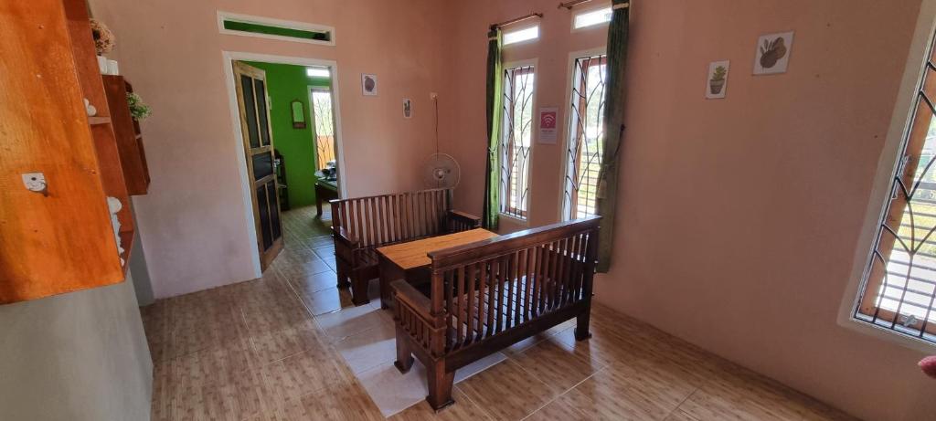 a hallway with two benches and a table in a room at Dam Ri Private 2nd Floor - Near Airport & Batukaras in Tjidjulang