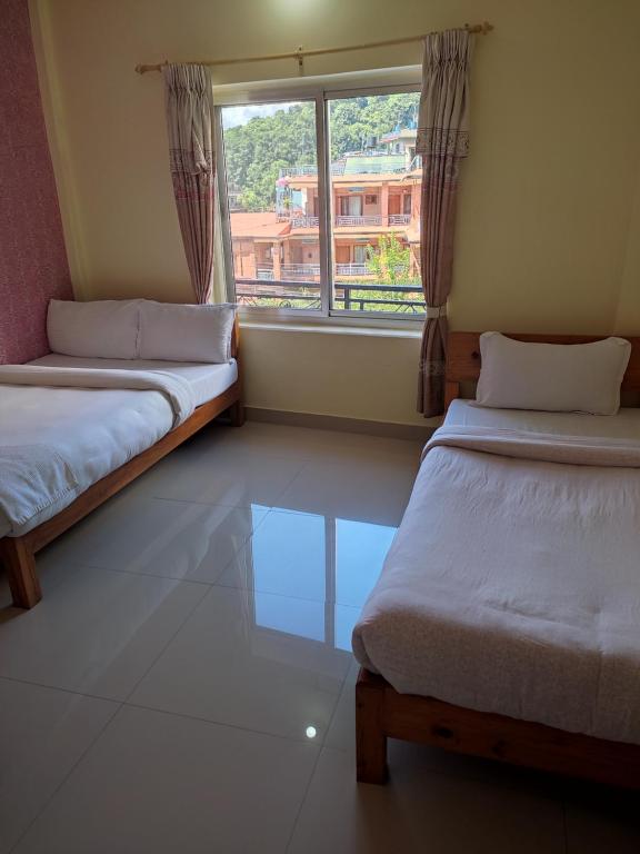 Ein Bett oder Betten in einem Zimmer der Unterkunft Hotel Green Hill View
