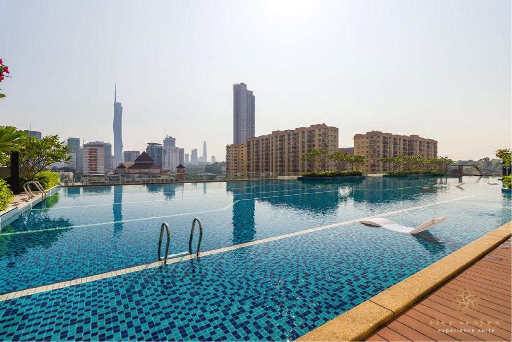 a swimming pool with a city skyline in the background at Sentral Suites Kuala Lumpur, Five Senses in Kuala Lumpur