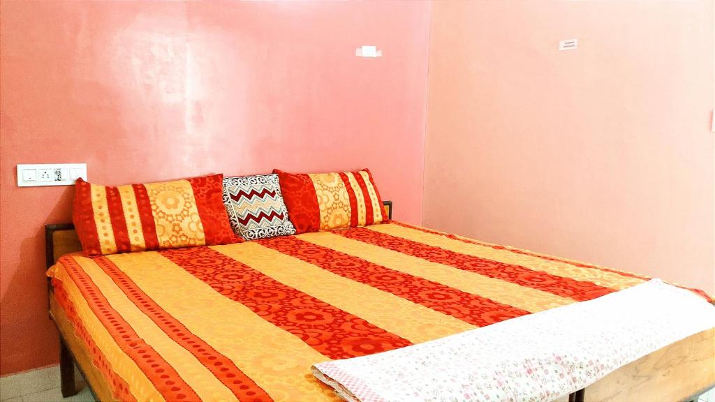 a bed with a colorful comforter in a room at HOTEL HELIX -- RAJPURA -- Budget Rooms for Family, Couples, Solo Travellers in Rājpura