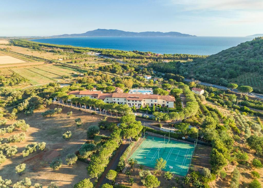 an aerial view of a resort with a pool and the ocean at Argentario Osa Resort in Talamone