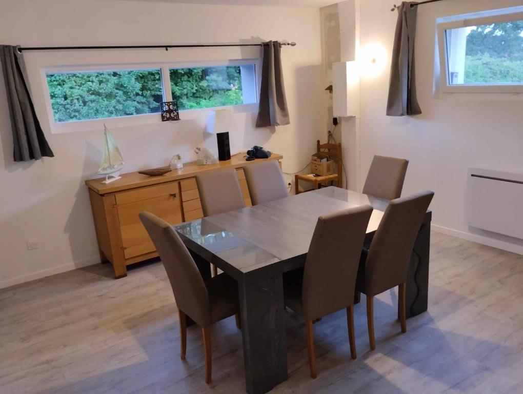 a dining room with a table and chairs and a desk at Maison rénovée in Millières